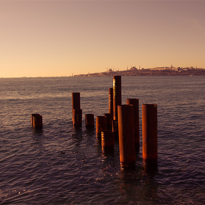 Rusty steel pipe stakes coming from out of the sea